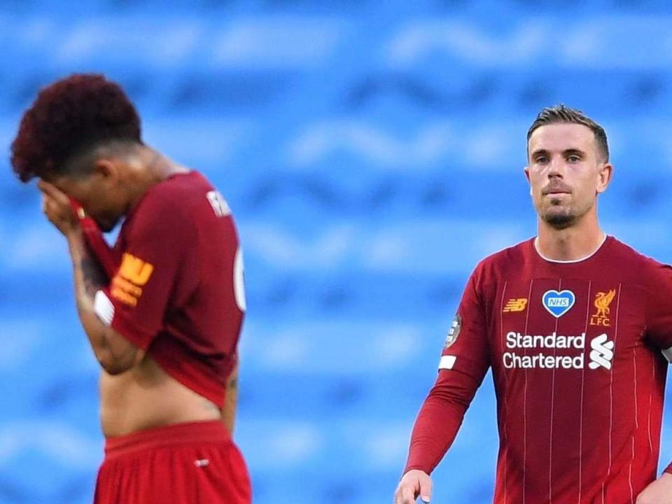 Jordan Henderson, right, reacts after Manchester City's third goal: Getty