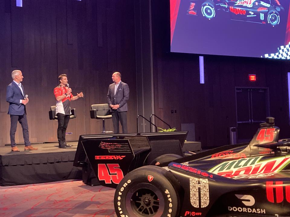 Hy-Vee CEO Randy Edeker (right) stands next to IndyCar race Jack Harvey (center) and Bud Denkerm president of the Penske Corporation.