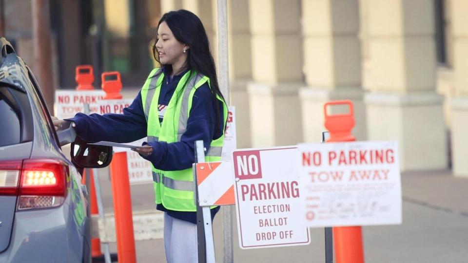 Poll worker Karen Lun is handed a ballot at the drop off point on Monterey St. Ballots were being collected at the San Luis Obispo Clerk-Recorder’s office at the Katcho Achadjian Government Center during the Super Tuesday election March 5, 2024. David Middlecamp/dmiddlecamp@thetribunenews.com