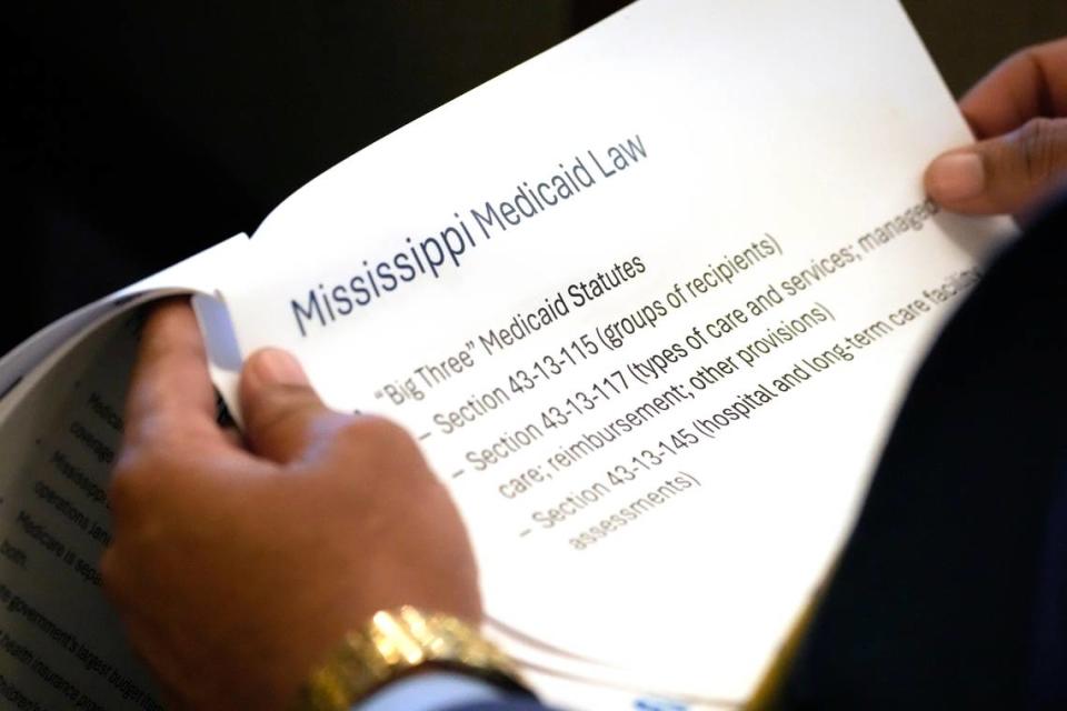 A member of the Mississippi House of Representatives studies an panel of the outline on Mississippi Medicaid provided Wednesday to the House Medicaid Committee at the Mississippi Capitol.