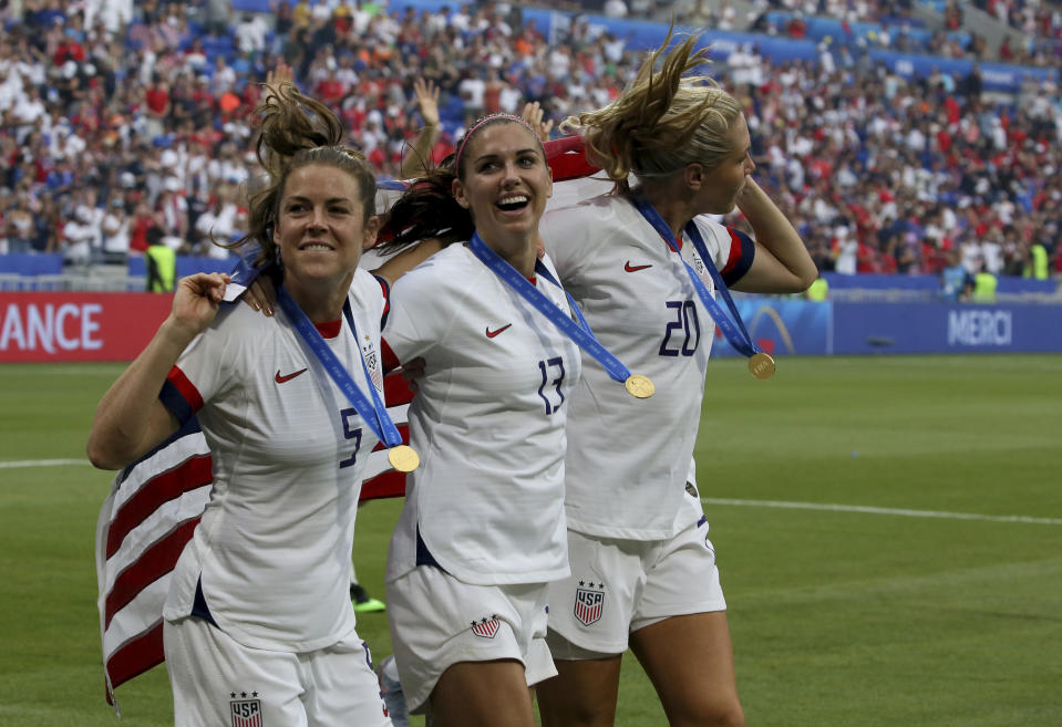 From left: United States' Kelley O Hara, United States' Alex Morgan and United States' Allie Long celebrate their victory in the Women's World Cup final soccer match between US and The Netherlands at the Stade de Lyon in Decines, outside Lyon, France, Sunday, July 7, 2019. US won 2:0. (AP Photo/David Vincent)