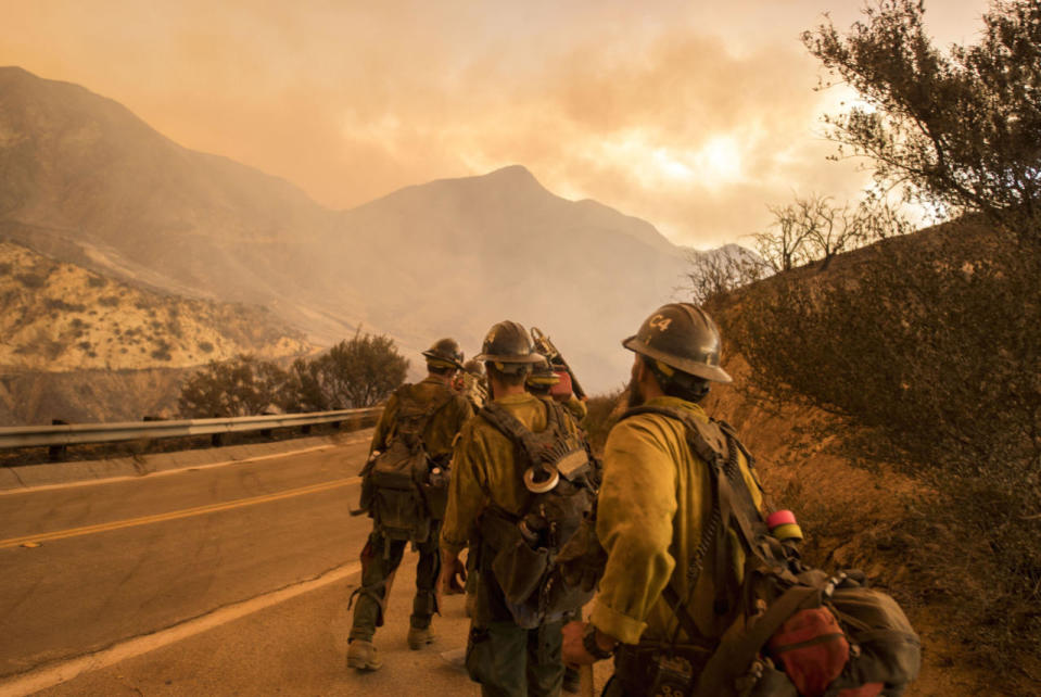 <p>Firefighters head towards the blaze. (Rex)</p>