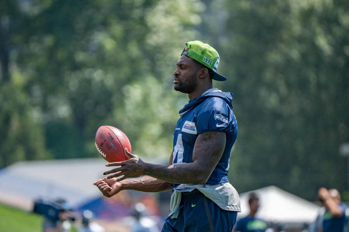 Seattle Seahawks wide receiver DK Metcalf handles the ball as he watches instead of practices on the first day of training camp at the Virginia Mason Athletic Center in Renton on July 27, 2022.