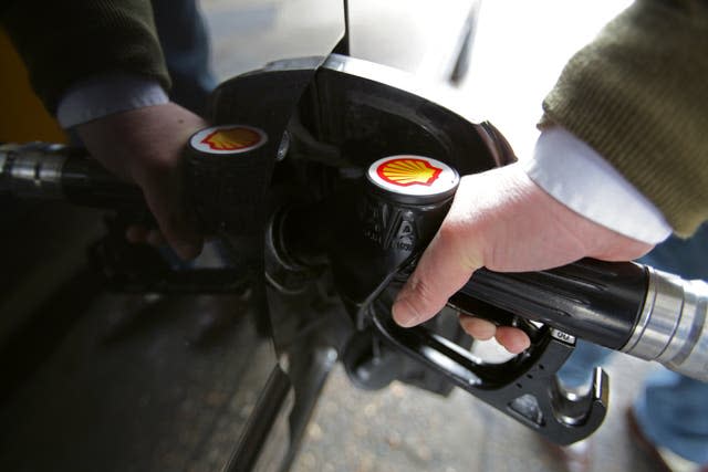 A customer filling up his car at a petrol station (Yui Mok/PA)