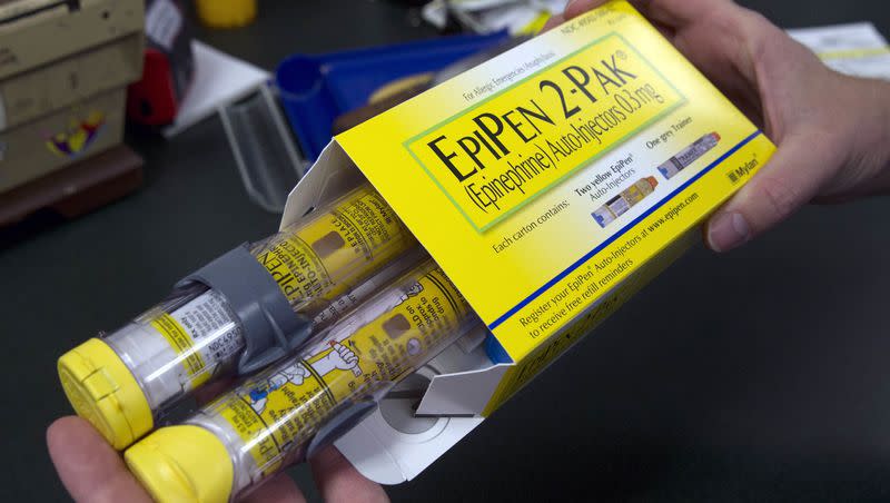 A pharmacist holds a package of EpiPens epinephrine auto-injector, a Mylan product, in Sacramento, Calif. on July 8, 2016.