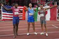 Gold medalist Lamont Marcell Jacobs, centre, of Italy, poses for a photo with silver medalist Fred Kerley, of the United States, and bronze medalist Andre de Grasse, right, of Canada, after the men's 100-meters the men's 100-meters at the 2020 Summer Olympics, Sunday, Aug. 1, 2021, in Tokyo. (AP Photo/David J. Phillip)