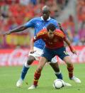 Italian forward Mario Balotelli (L) vies with Spanish midfielder Sergio Busquets during the Euro 2012 championships football match Spain vs Italy on June 10, 2012 at the Gdansk Arena. AFP PHOTO / CHRISTOF STACHECHRISTOF STACHE/AFP/GettyImages