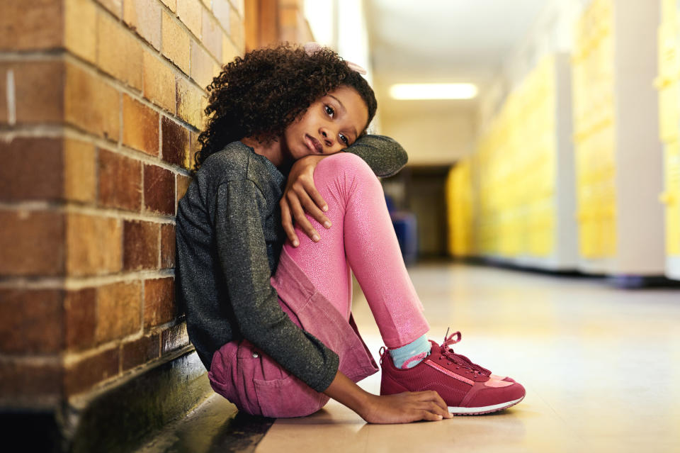 A young girl looking sad