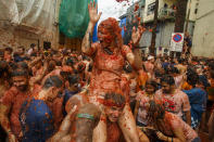 <p>Revellers enjoy the atmosphere in tomato pulp while participating the annual Tomatina festival on Aug. 30, 2017 in Bunol, Spain. An estimated 22,000 people threw 150 tons of ripe tomatoes in the world’s biggest tomato fight held annually in this Spanish Mediterranean town. (Photo: Pablo Blazquez Dominguez/Getty Images) </p>