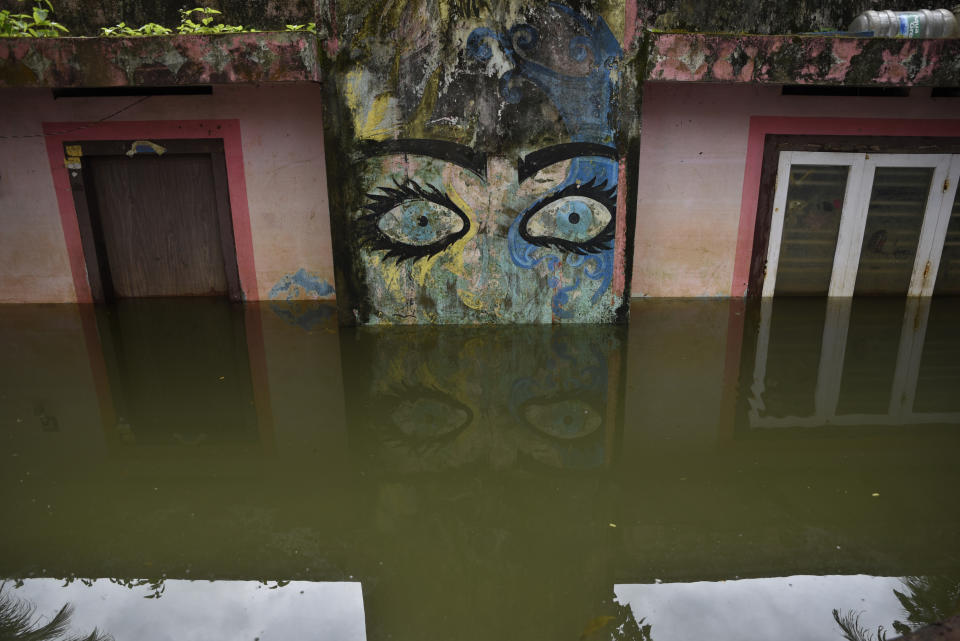 In this Aug. 27, 2018, file photo, a wildly painted house is seen partially submerged as flood waters recede in Kuttanad, Alappuzha in the southern state of Kerala, India. More than 300 people died and 800,000 were displaced by the worst monsoon flooding in a century in the southern Indian state of Kerala this month. (AP Photo/R S Iyer, File)