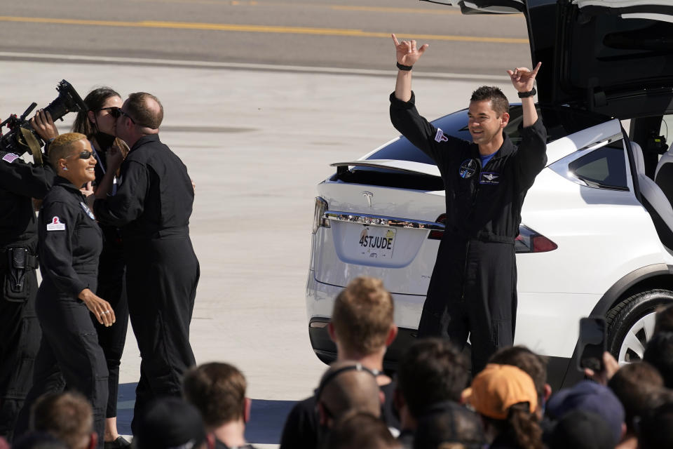 FILE - Inspiration4 crew member Jared Isaacman, right, waves to family members before a trip to Kennedy Space Center's Launch Pad 39-A and a planned liftoff on a SpaceX Falcon 9 rocket, Sept. 15, 2021, in Cape Canaveral, Fla. New research presents the largest set of information yet regarding how the human body reacts to spaceflight. (AP Photo/John Raoux, File)