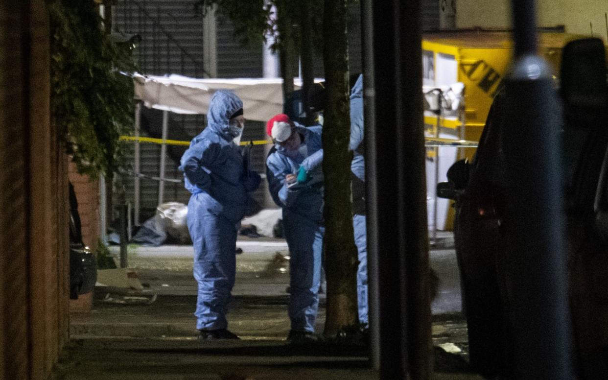 Forensics officers at the scene in Seven Kings, Ilford after a multiple stabbing - PA