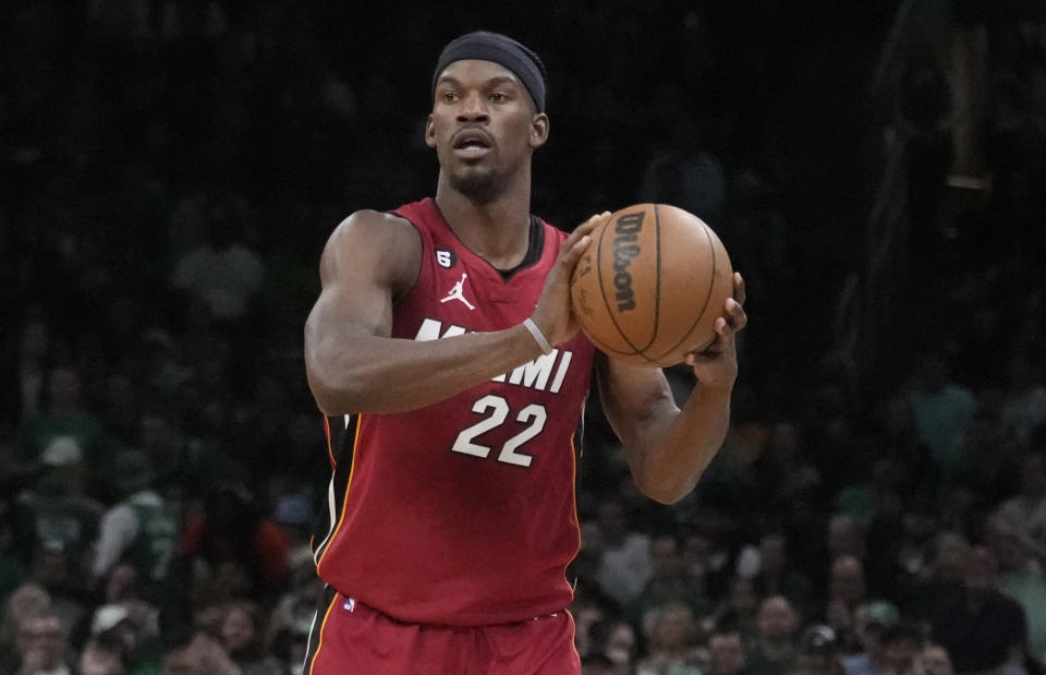 FILE - Miami Heat forward Jimmy Butler (22) looks to pass the ball during Game 2 of the team's NBA basketball Eastern Conference finals against the Boston Celtics, May 19, 2023, in Boston. Butler dressed just like a member of the ball crew at the U.S. Open tennis tournament Wednesday to perform those duties and picked up a racket to play alongside Frances Tiafoe during a charity event that raised $320,000 for humanitarian relief in Ukraine. (AP Photo/Charles Krupa, File)