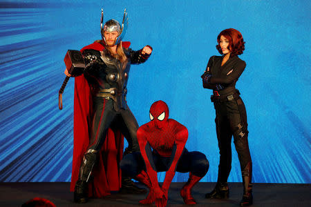 Performers dressed as Marvel characters (L-R) Thor, Spider-Man and Black Widow pose during a presentation on Hong Kong Disneyland's resort expansion and development plan in Hong Kong, China November 22, 2016. REUTERS/Bobby Yip