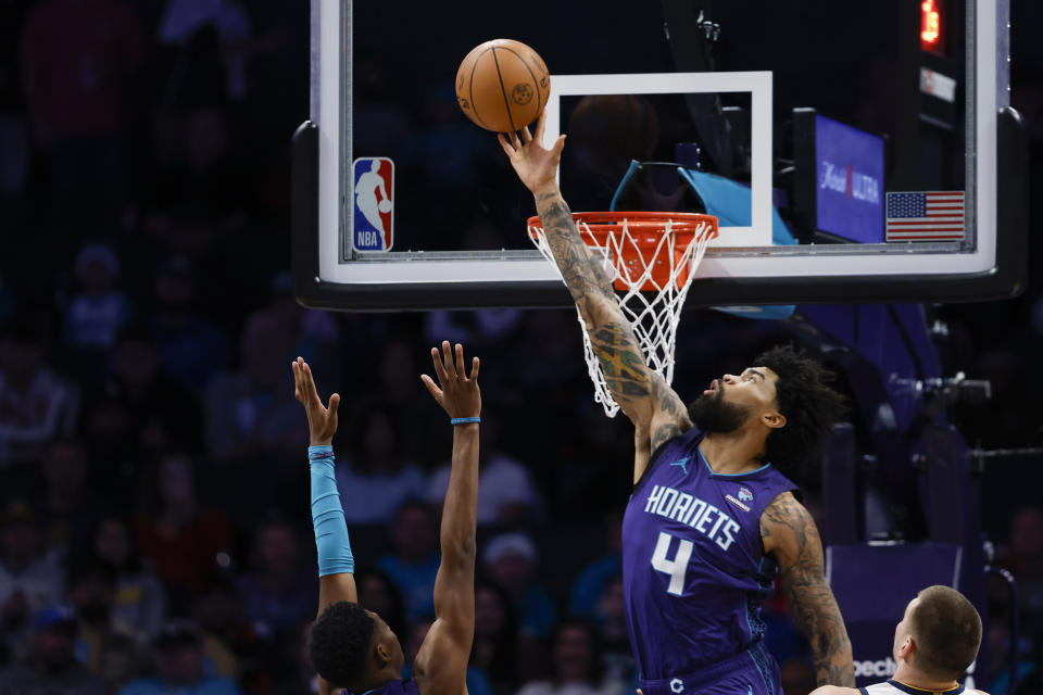 Charlotte Hornets center Nick Richards (4) blocks a Denver Nuggets shot during the first half of an NBA basketball game in Charlotte, N.C., Saturday, Dec. 23, 2023. (AP Photo/Nell Redmond)