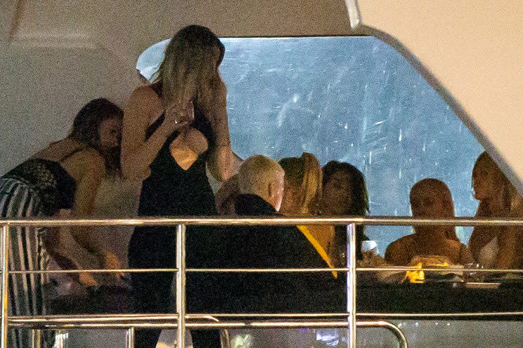 Justin Bieber parties on a boat with a bunch of models. (Photo: Splash News)