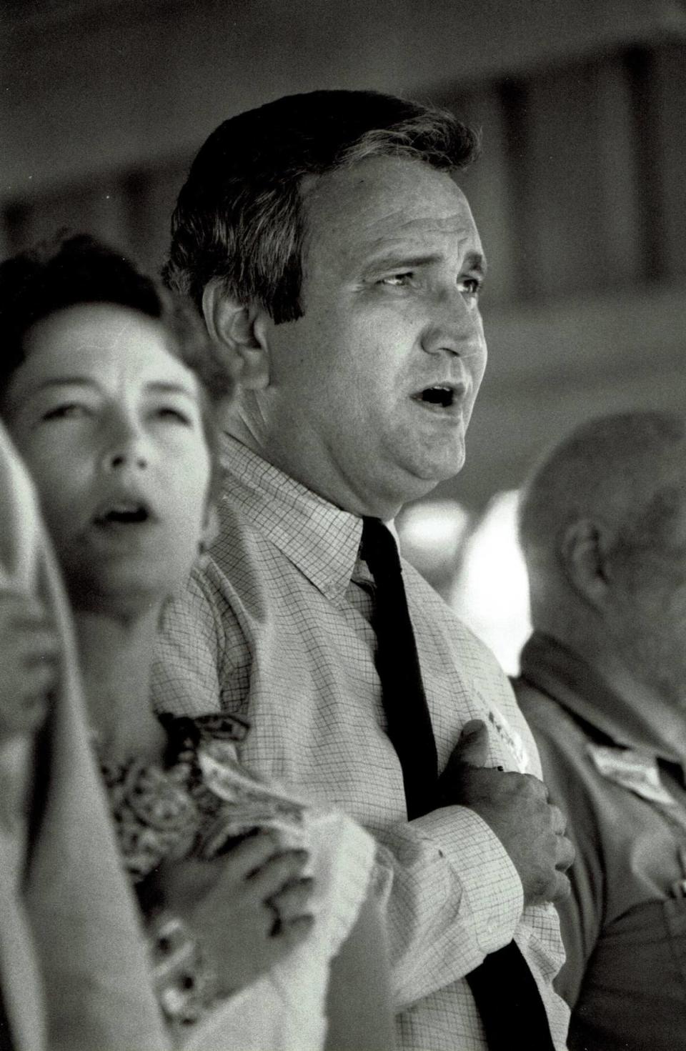 Republican candidate for governor, Larry Forgy, sang the National Anthem at the start of speeches at the 106th annual Fancy Farm political picnic in August 1986. Forgy withdrew from the race in 1987 citing difficulty with fundraising. His party’s nominee, John R. Harper, was defeated by Democratic businessman Wallace Wilkinson for the governor’s office. This year’s annual political event and fundraiser for St. Jerome Catholic Church in Graves County is today. Photo by Charles Bertram | Staff