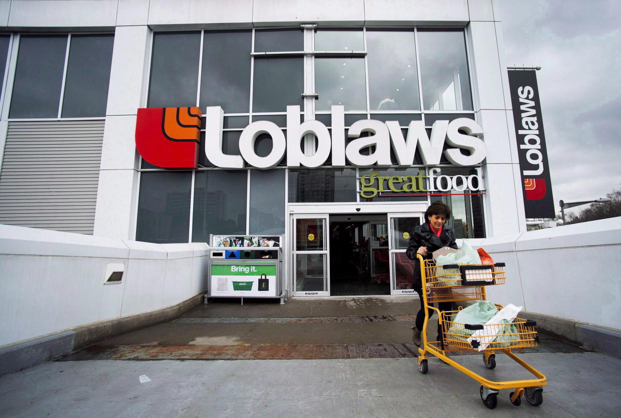 A woman carts out her groceries from a Loblaws grocery store in Toronto on May 1, 2014. THE CANADIAN PRESS/Nathan Denette