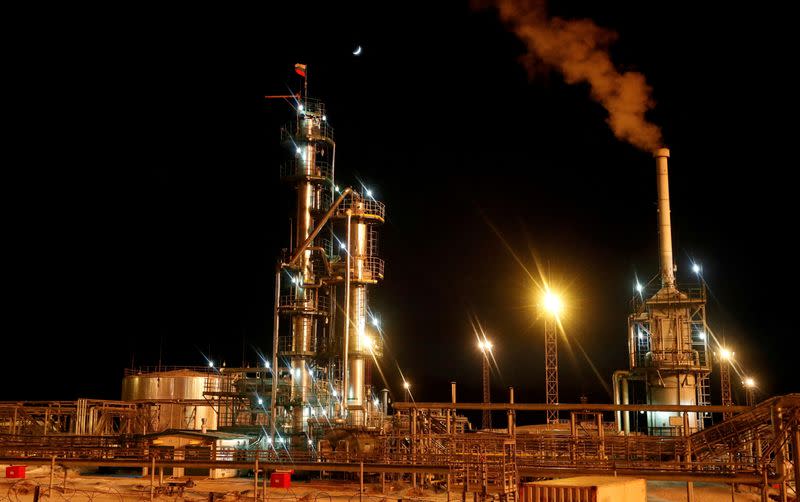 FILE PHOTO: A Russian state flag flies on the top of a diesel plant in the Irkutsk Oil Company-owned Yarakta Oil Field in Irkutsk Region