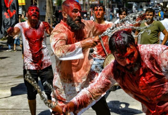 Lebanese Shiite Muslim men flagellate themselves after cutting their scalps to bleed, in a mourning ritual for Ashura in the southern Lebanese city of Nabatiyeh