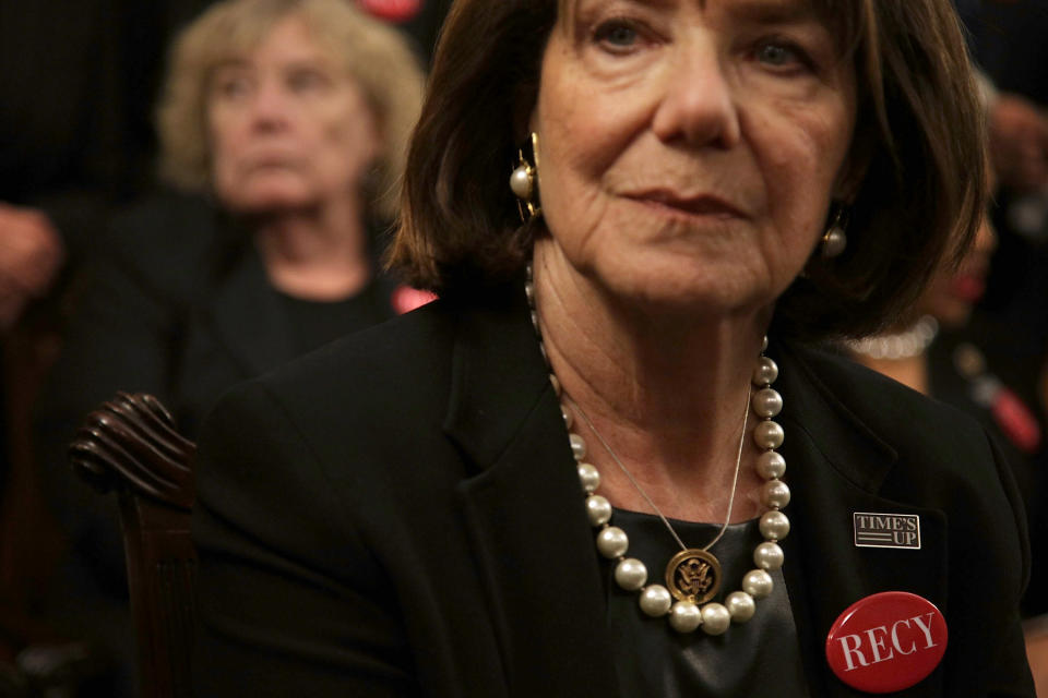 Rep. Susan Davis (D-Calif.) wears black with a "Time's Up" pin and a "RECY" button.