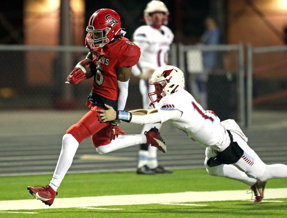 Trystan Haynes is chased by Skyler Moorman during a pick six interception and touchdown as the Carl Albert Titans play Collinsville in State Championship Playoff High School Football on Nov 17, 2023; Midwest City, Oklahoma, USA; at Carl Albert High School. Mandatory Credit: Steve Sisney-The Oklahoman