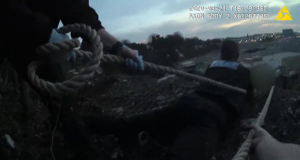 Screengrab from bodycam footage dated 21/03/20 photo issued by Kent Police of police attempting to rescue a man from a 50ft cliff over a quarry in Northfleet. (PA)