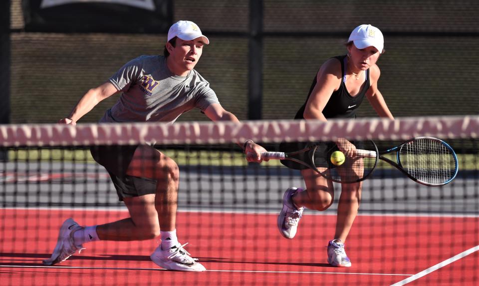 Wylie's Trevor Short plays a shot in front of partner Stealey Crousen during their mixed doubles final against teammates Marshall McPherson and Carly Bontke. Short and Crousen won the match 6-1, 6-2 to win the Region I-5A title April 11 at Texas Tech's McLeod Tennis Center in Lubbock.