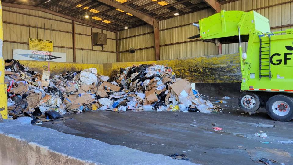 A worker compacts trash on April 25 at the Henderson County Sold Waste Transfer Station.