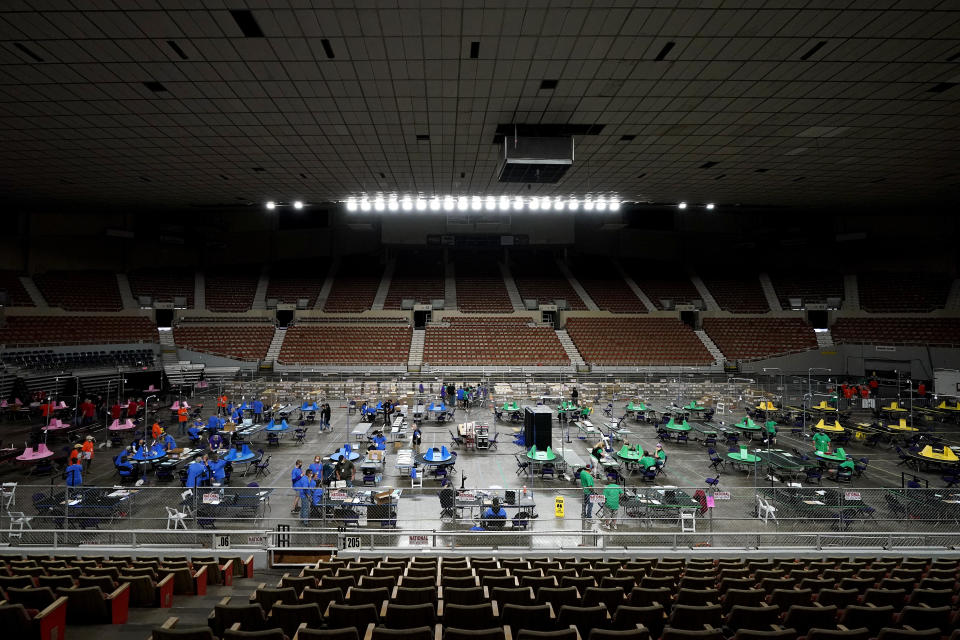 Maricopa County ballots cast in the 2020 general election are examined and recounted by contractors working for Florida-based company, Cyber Ninjas, Thursday, May 6, 2021 at Veterans Memorial Coliseum in Phoenix. The audit, ordered by the Arizona Senate, has the U.S. Department of Justice saying it is concerned about ballot security and potential voter intimidation arising from the unprecedented private recount of the 2020 presidential election results. (AP Photo/Matt York, Pool)