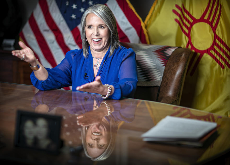 FILE - New Mexico Gov. Michelle Lujan Grisham smiles after delivering the State of the State address during the 56th legislative session, Jan. 18, 2022, in Santa Fe, N.M. Grisham is promoting her management of the economy and health care during the COVID-19 pandemic, support for abortion access and expanded social programs, including tuition-free college for New Mexico residents and expanded access to preschool and no-pay child care. (Jim Weber/Santa Fe New Mexican via AP, Pool, File)