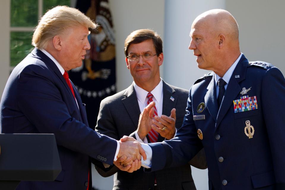 President Donald Trump, joined by Secretary of Defense Mark Esper, shakes hands with Gen. John "Jay" Raymond on Aug. 29, 2019.