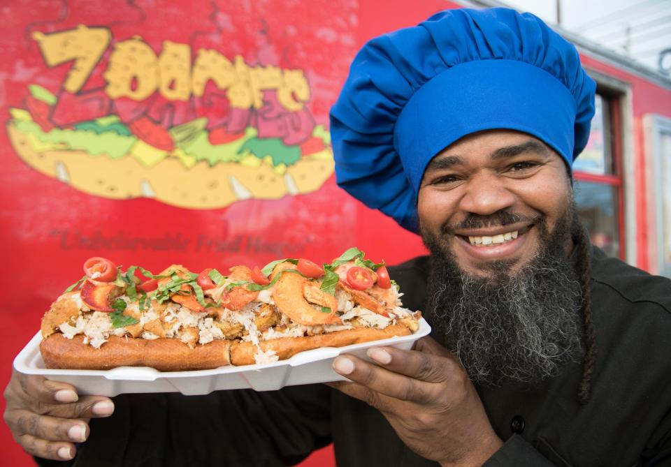 Ezell Barnes, owner and creator of the Zoagies food truck in Pennsville, displays a Zochness Monster of the Zea, which is a xtra-large deep-fried hoagie roll filled with fish, shrimp, crab, and lobster.  