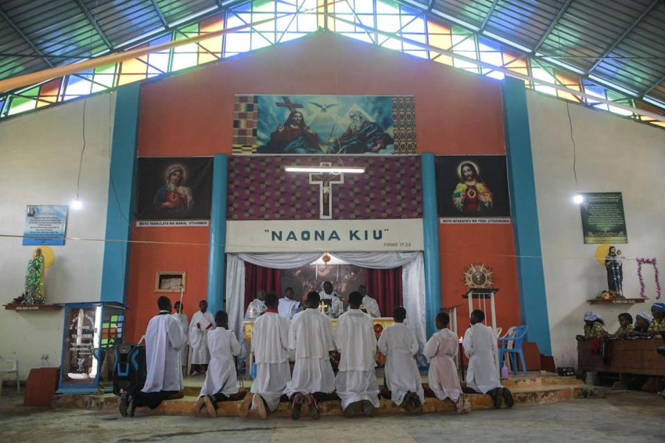 A bishop blesses worshippers during an early morning mass at St. Mary’s Catholic Church in Yamumbi, Kenya. <a href="https://www.gettyimages.com/detail/news-photo/eldoret-catholic-bishop-dominic-kimengich-blesses-news-photo/1242496951?adppopup=true" rel="nofollow noopener" target="_blank" data-ylk="slk:Simon Maina/AFP via Getty Images;elm:context_link;itc:0;sec:content-canvas" class="link ">Simon Maina/AFP via Getty Images</a>