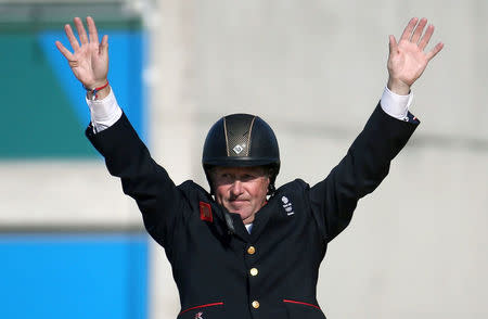 FILE PHOTO: 2016 Rio Olympics - Equestrian - Victory Ceremony - Jumping Individual Victory Ceremony - Olympic Equestrian Centre - Rio de Janeiro, Brazil - 19/08/2016. Nick Skelton (GBR) of Britain celebrates winning the gold medal. REUTERS/Pilar Olivares/File Photo