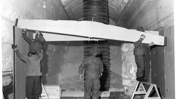 Men place a truss to the permanent camp at Camp Century, Greenland.