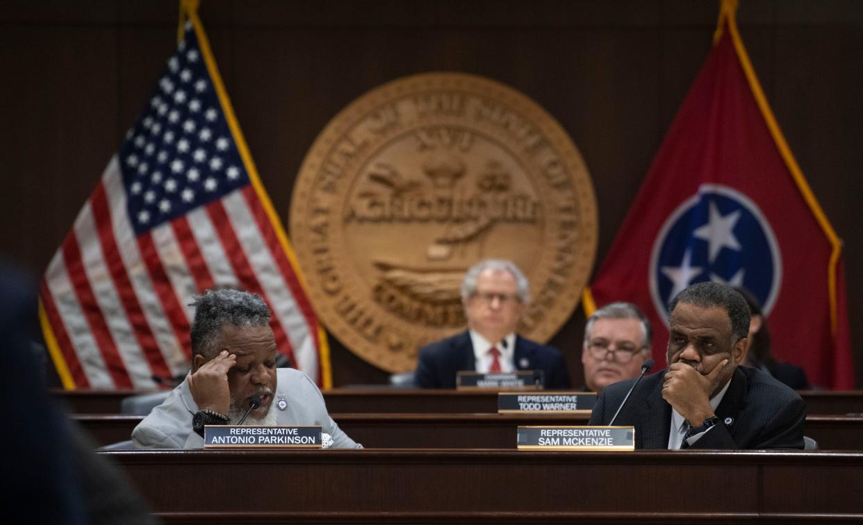 Rep. Antonio Parkinson, D-Memphis, and Rep. Sam McKenzie, D-Knoxville, discuss a school voucher bill during a House committee hearing on March 6 as Chairman Mark White, R-Memphis, (back center) listens.