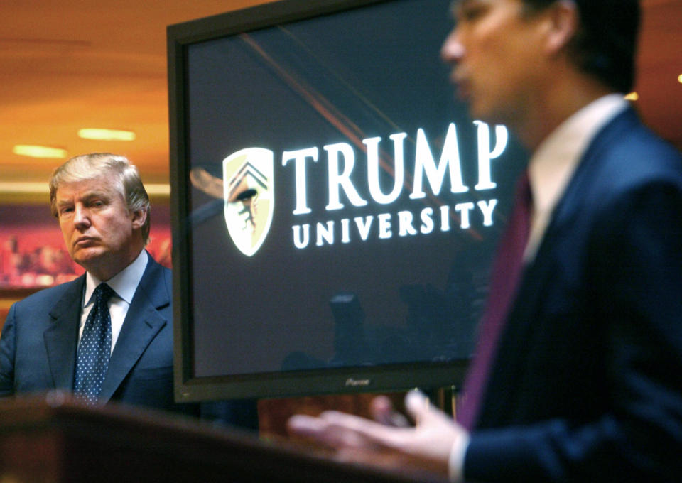 Donald Trump, left, listens as Michael Sexton introduces him at a news conference in New York where he announced the establishment of Trump University on May 23, 2005. (AP Photo/Bebeto Matthews)