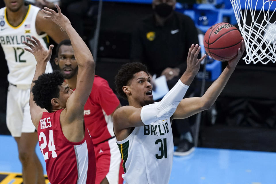 Baylor guard MaCio Teague (31) shoots ahead of Houston guard Quentin Grimes (24) during the second half of a men's Final Four NCAA college basketball tournament semifinal game, Saturday, April 3, 2021, at Lucas Oil Stadium in Indianapolis. (AP Photo/Darron Cummings)