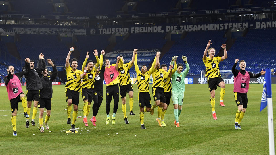 Dortmund players celebrate at the end of the German Bundesliga soccer match between FC Schalke 04 and Borussia Dortmund in Gelsenkirchen, Germany, Saturday, Feb. 20, 2021. Dortmund won 4-0. (AP Photo/Martin Meissner, Pool)