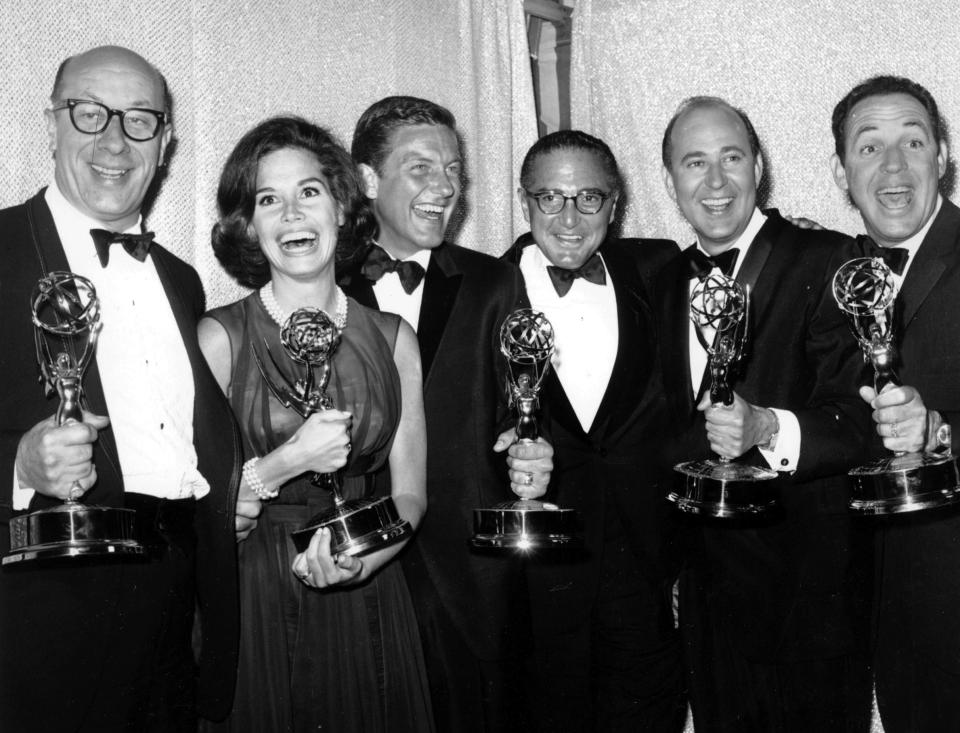 FILE - In this May 24, 1964 file photo, cast and crew of the television comedy series "The Dick Van Dyke Show" from left, Richard Deacon, Mary Tyler Moore, Outstanding Continued Performance by an Actress in a Series, Lead; Dick Van Dyke, Outstanding Continued Performance by an Actor in a Series, Lead; Sheldon Leonard, producer of the show, which was named best comedy series; Carl Reiner, Outstanding Writing Achievement in a Series; and Jerry Paris, Outstanding Directorial Achievement in Comedy. pose with their awards at the 16th Annual Emmy Awards in Los Angeles. Variety reported that Reiner died of natural causes on Monday night, June 29, 2020, at his home in Beverly Hills, Calif. He was 98. (AP Photo, File)