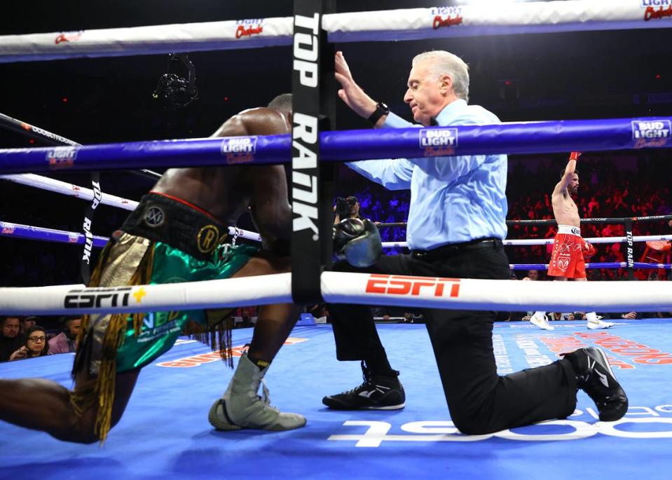 Jose Ramirez knocks-down Richard Commey during their junior welterweight fight at Save Mart Center on March 25, 2023 in Fresno, California.