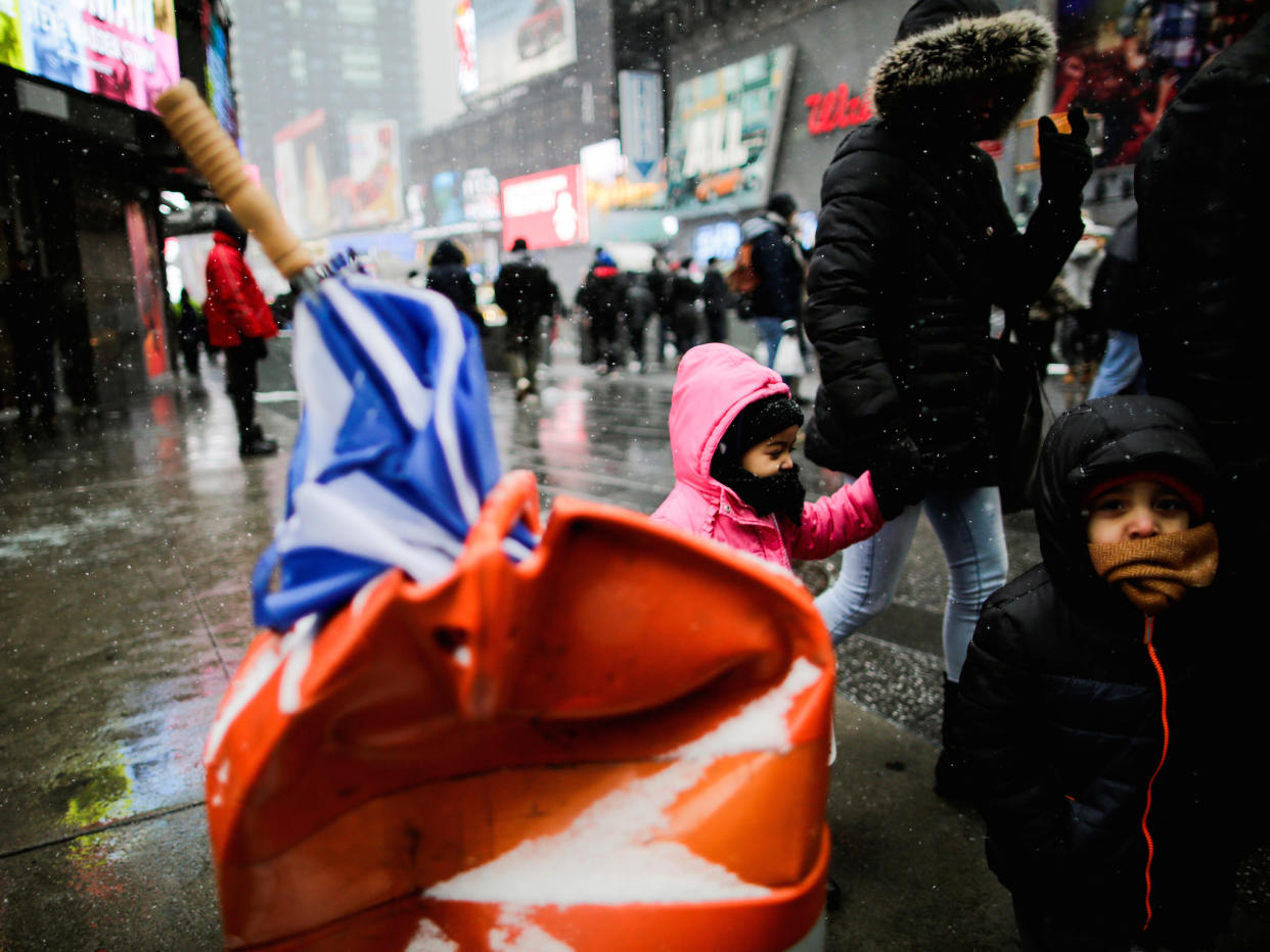 People walk around Times Square as a cold weather front hits the region in Manhattan, New York: REUTERS