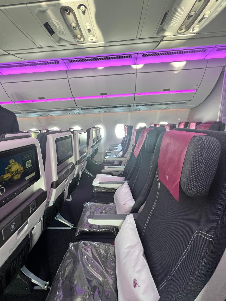 The center three black seats in economy class onboard a Qatar Airways A350