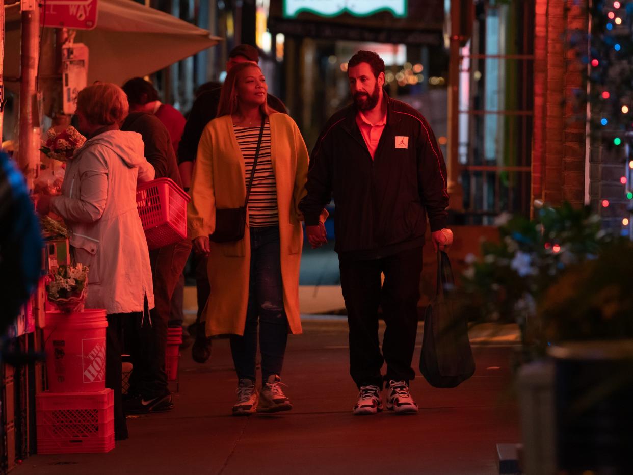 Queen Latifah and Adam Sandler walking down a streen in Philadelphia