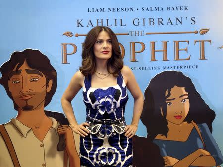 Movie star Salma Hayek poses in front of a billboard for her movie "The Prophet" in Beirut, Lebanon April 27, 2015. REUTERS/Aziz Taher