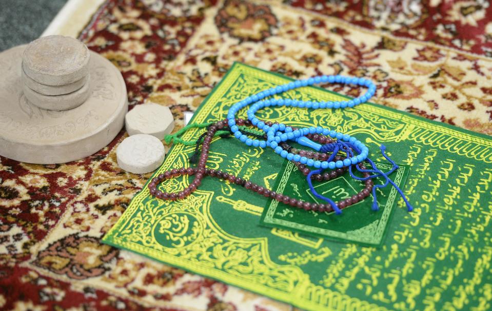 A prayer rug and beads used during Islamic prayer.