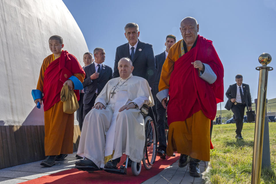 Pope Francis, center, arrives at a meeting with religious leaders at the Hun Theatre in the Sky Resort compound some 15 kilometers south of the Mongolian capital Ulaanbaatar, Sunday, Sept. 3, 2023. Pope Francis has praised Mongolia’s tradition of religious freedom dating to the times of founder Genghis Khan during the first-ever papal visit to the Asian nation.(AP Photo/Louise Delmotte)