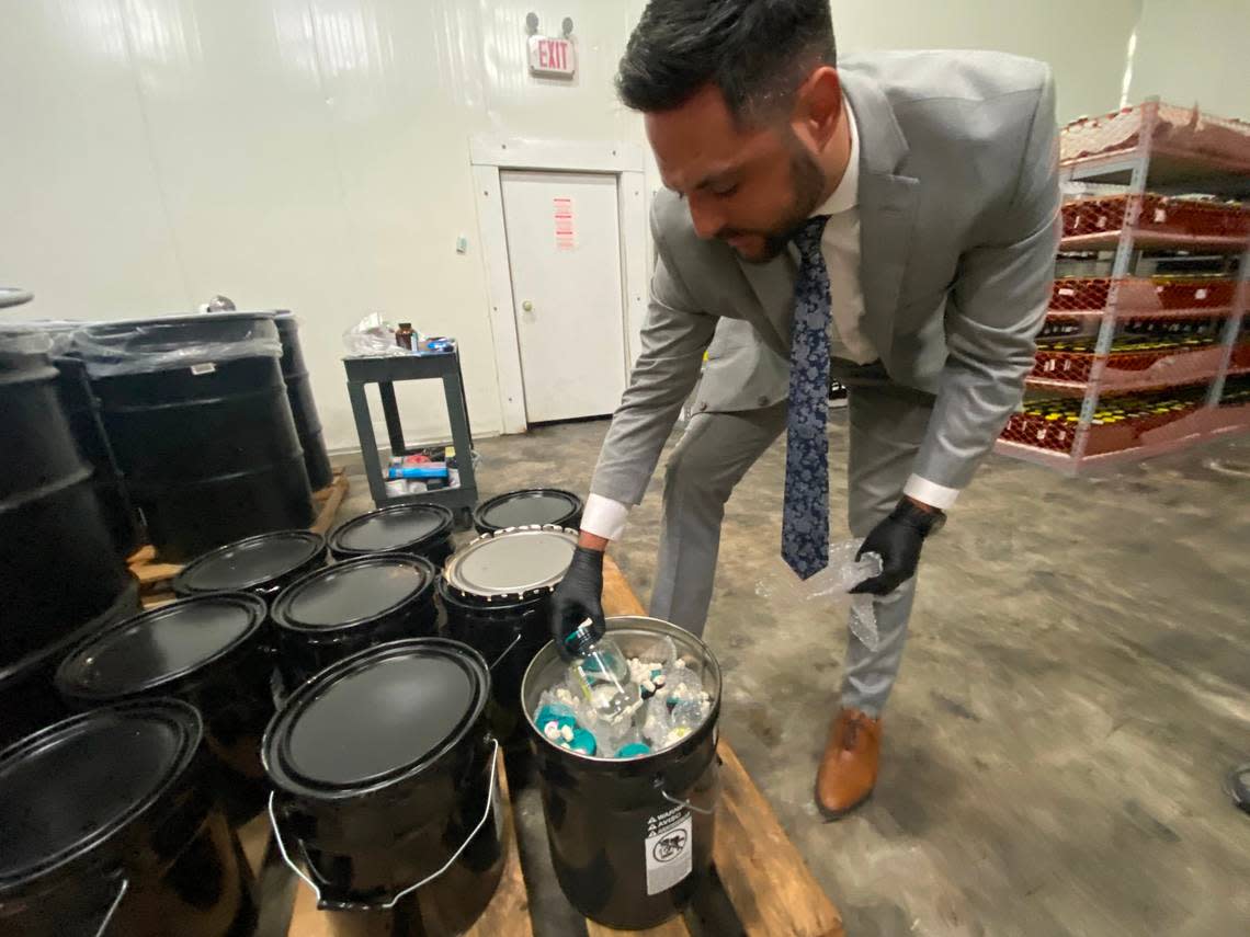 Dylan Boigris, a Coconut Grove trial attorney, inspectes samples from the 2010 BP Deepwater Horizon oil spill that are being stored in a South Florida warehouse.