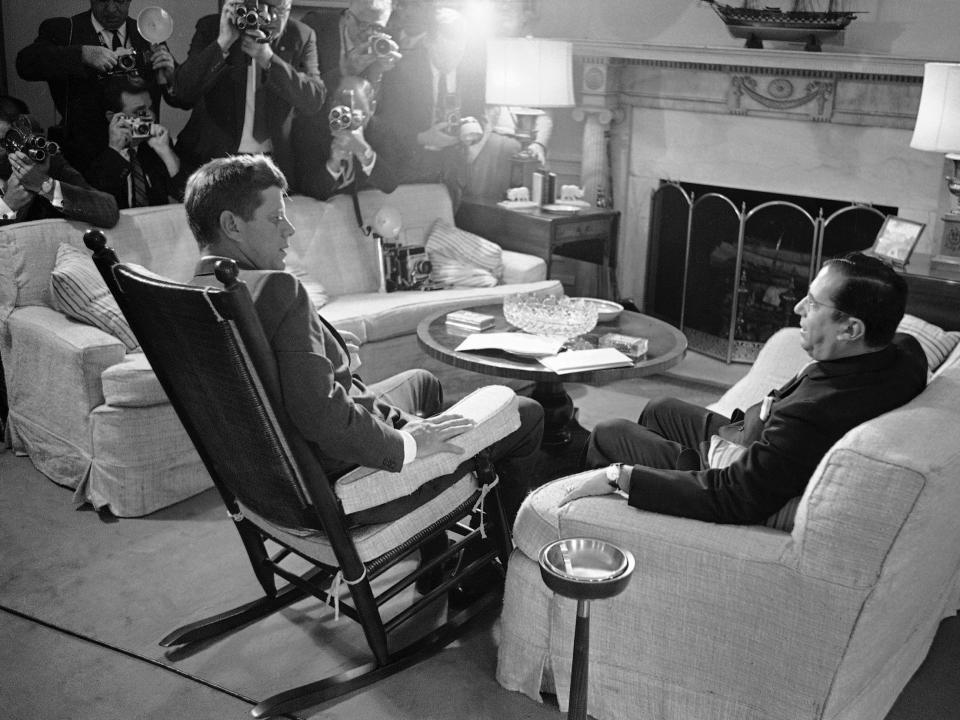 President John F. Kennedy talks with Brazilian Ambassador Roberto de Oliveira Campos at the White House in 1961.